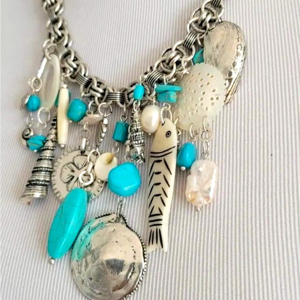Turquoise and silver tone charm necklace
